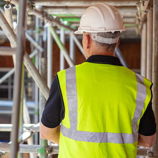 construction workers looking at buildings
