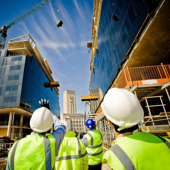 construction workers looking at buildings